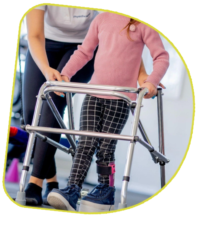 Child walking with support walker during physical therapy.